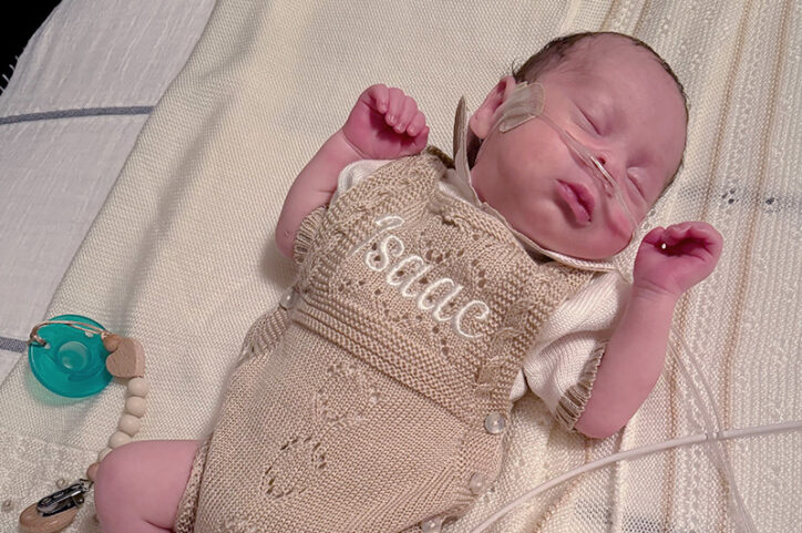 Baby Isaac in a knit onesie with his name on it