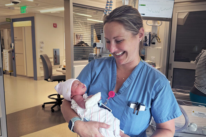 Nurse Bonnie holds Isaac 