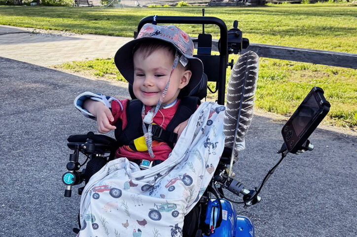 Maxwell sits in his motorized wheelchair