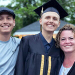 Ricky in cap and gown flanked by Jerry and Heather, after being treated for cerebral adrenoleukodystrophy.