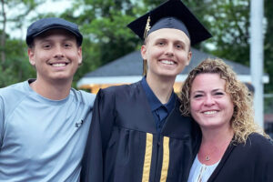 Ricky in cap and gown flanked by Jerry and Heather, after being treated for cerebral adrenoleukodystrophy.