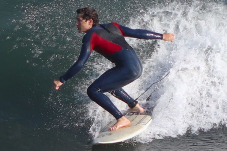 Griffin surfing after his second knee was operated on.