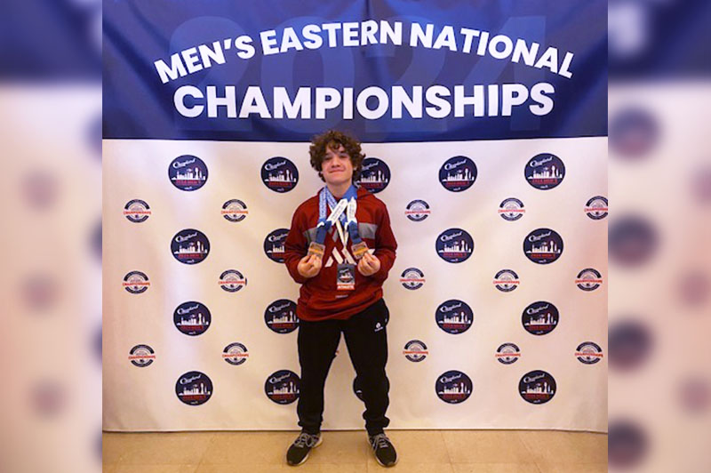 Kaleb shows off his medals at the Men's Eastern National Championships.