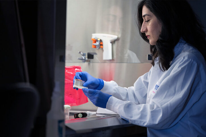 Izadifar in the lab, working with an organ chip under a hood