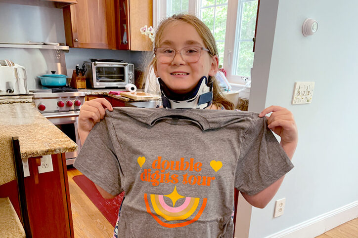 Charlotte shows off her double digits tour birthday T-shirt.