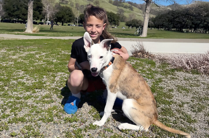 Asa posing in a park with his new dog.