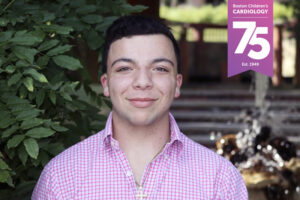 Jack, 23, smiles at the camera, with a banner graphic that says, "Boston Children's Cardiology 75, est. 1949."