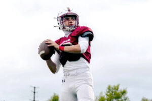 A high school football quarterback prepares to throw a pass.