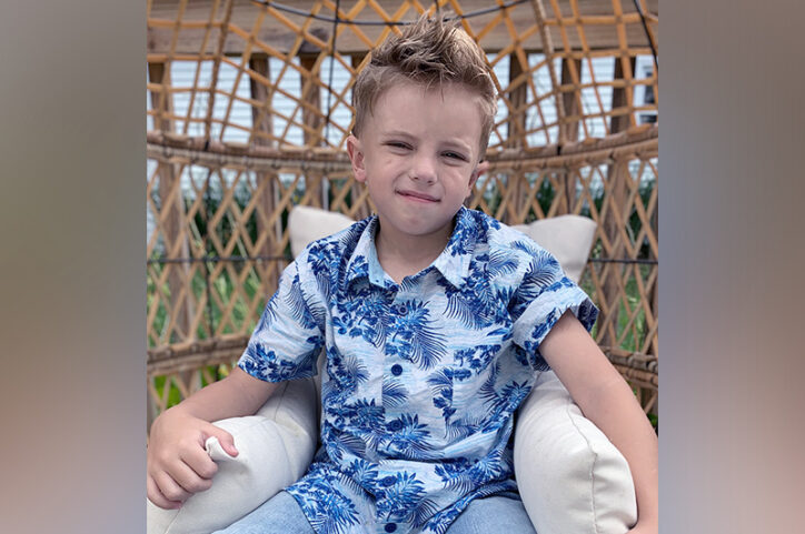 Jamison sits in a wicker chair.