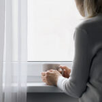 A woman gazing out of a window.