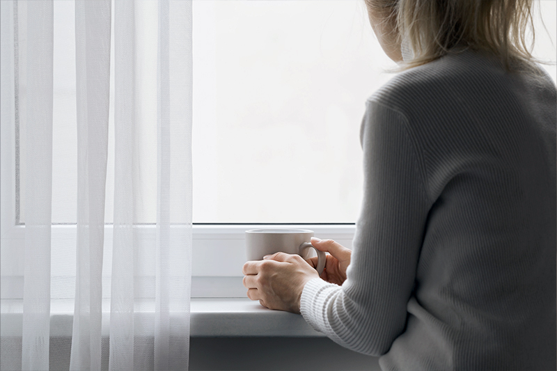 A woman gazing out of a window.