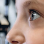 Close-up profile of a child’s face, focusing on their right eye during an eye examination.