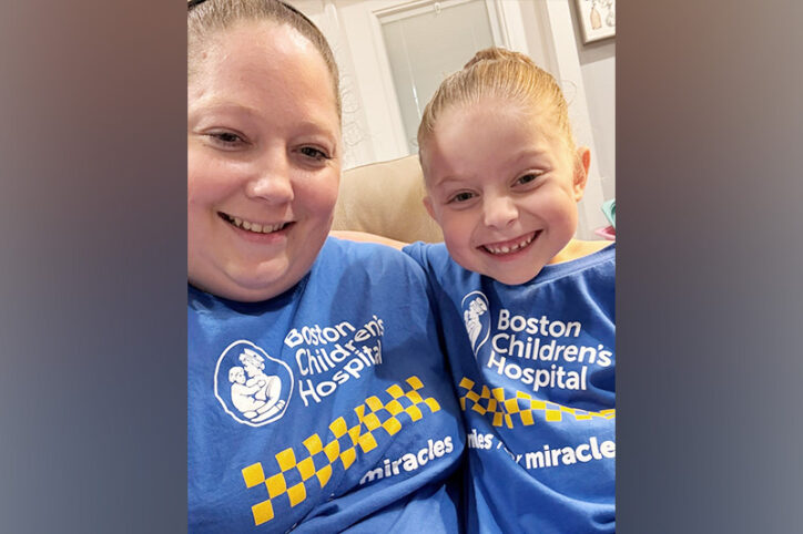 Mother and daughter smile together in matching Boston Children's t-shirts