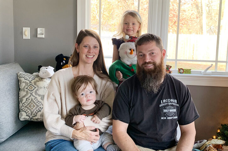 Jeremy's mother, Erica, holds him. She is sitting next to her daughter and husband.