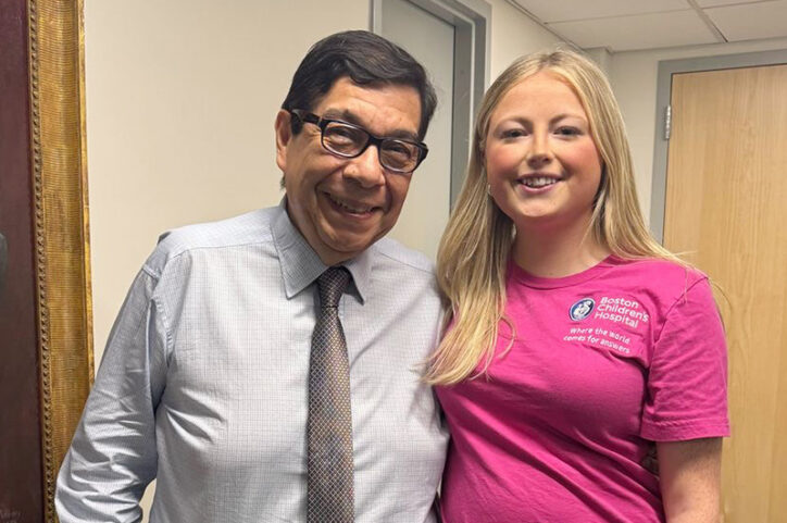 A man in glasses and a tie and a young woman smiling.