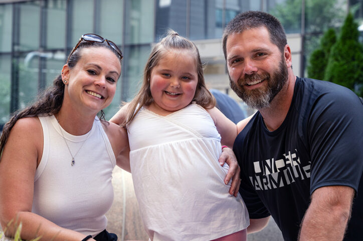 A young girl with her parents