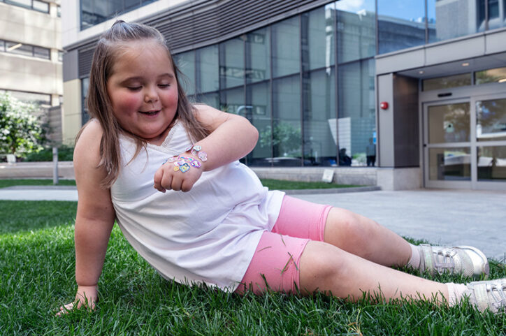 a young girl admires stickers on her hand