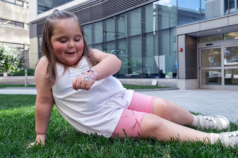 a young girl admires stickers on her hand